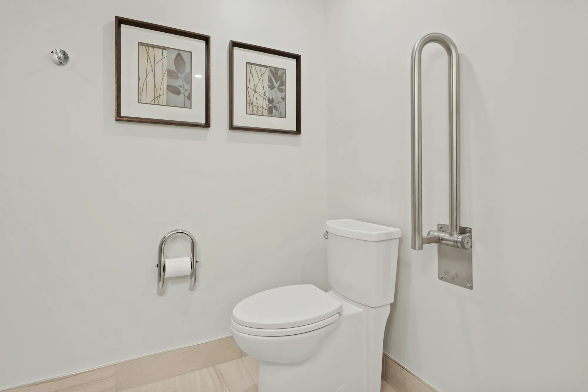 A bathroom fitted out with a walk-in shower and support rails